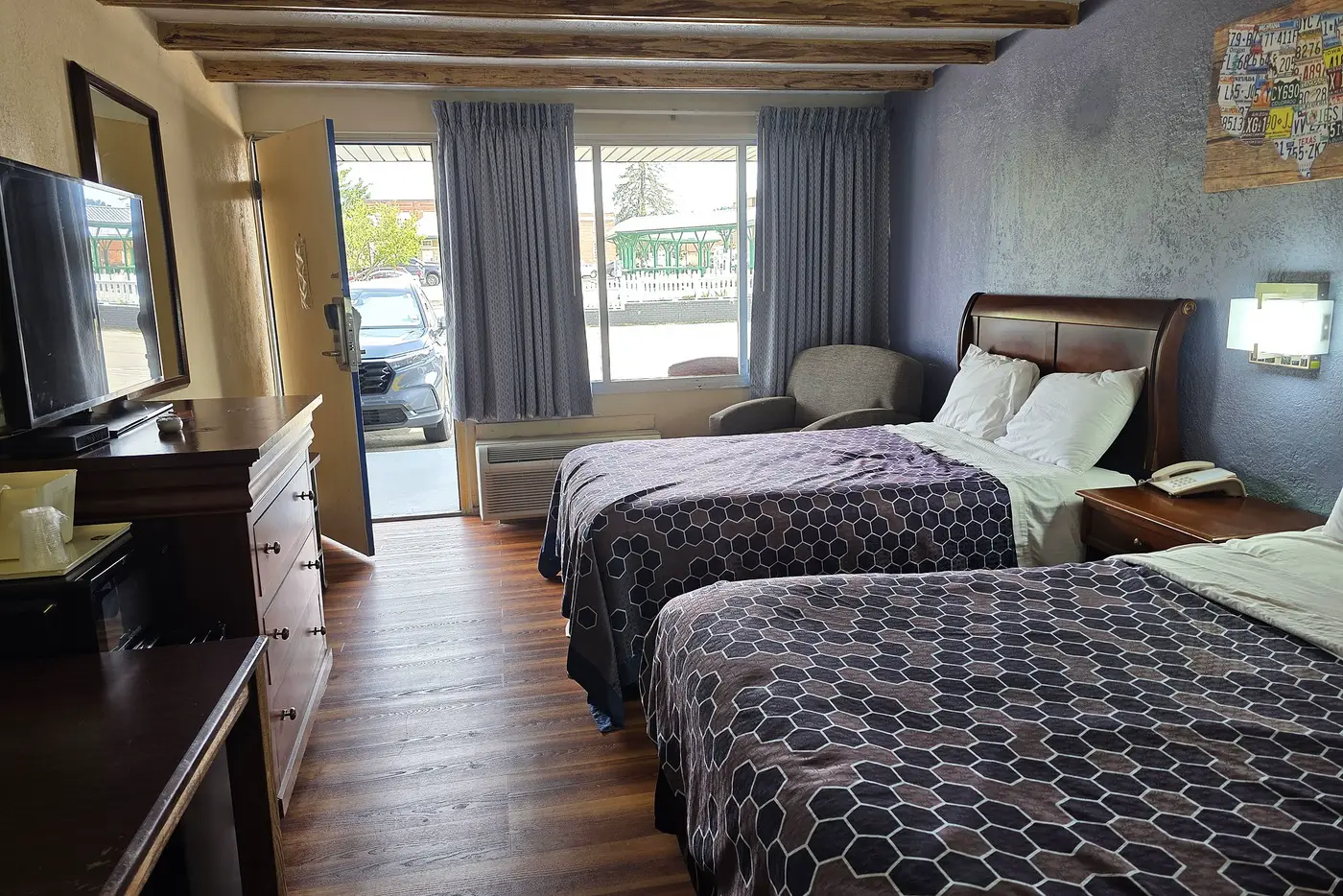 Guest room with the door open onto Main Street and the green market pavilion across the road